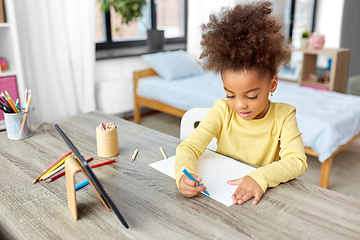 Image showing little girl drawing with coloring pencils at home