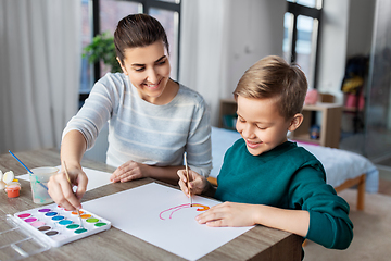 Image showing mother and son with colors drawing at home