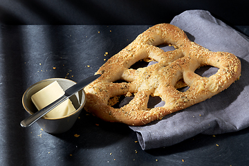 Image showing close up of cheese bread, butter and table knife