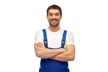 Image showing happy smiling male worker or builder in overall