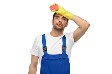 Image showing tired male cleaner with sponge