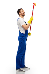 Image showing male cleaner in overal with window cleaning mop