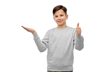 Image showing happy boy holding something imaginary on hand