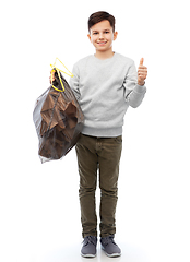 Image showing smiling boy with paper garbage in plastic bag