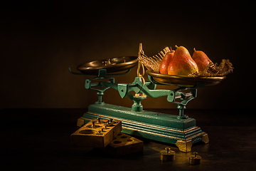 Image showing Organic pears on old vintage scales with brass weights on wooden background