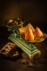 Image showing Organic pears on old vintage scales with brass weights on wooden background