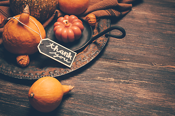 Image showing Happy Thanksgiving Day background, wooden table decorated with Pumpkins and Candles