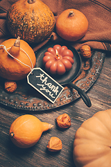 Image showing Happy Thanksgiving Day background, wooden table decorated with Pumpkins and Candles