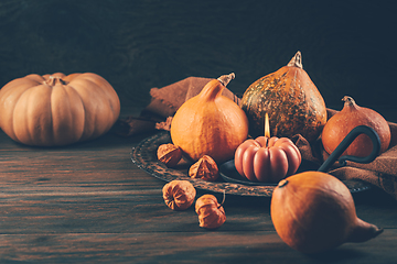 Image showing Happy Thanksgiving Day background, wooden table decorated with Pumpkins and Candles