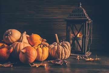 Image showing Assortment of pumpkins with autumn leaves on wooden background