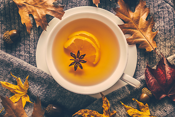 Image showing Hot lemon tea for cold  season with warm  sweater and autumn leaves