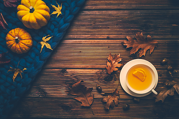 Image showing Hot lemon tea for cold  season with warm  blanket, pumpkins and autumn leaves