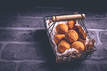 Image showing Homemade Arancini -  deep fried rice balls stuffed with Mozzarella cheese