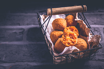 Image showing Homemade Arancini -  deep fried rice balls stuffed with Mozzarella cheese