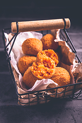 Image showing Homemade Arancini -  deep fried rice balls stuffed with Mozzarella cheese