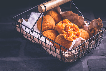 Image showing Homemade Arancini -  deep fried rice balls stuffed with Mozzarella cheese