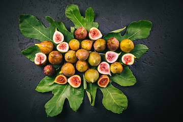 Image showing Harvesting - tasty organic figs on black background