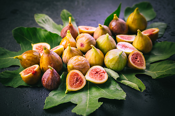 Image showing Harvesting - tasty organic figs on black background