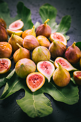 Image showing Harvesting - tasty organic figs on black background