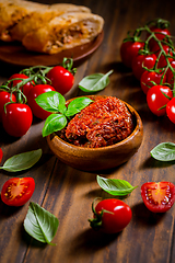 Image showing Sun dried and pickled tomatoes with fresh herbs and spices