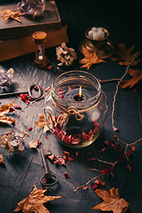 Image showing Fall candle decoration with dried leaves, autumn wooden home dec