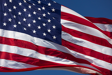 Image showing American Flag Waving In Wind Against a Deep Blue Sky