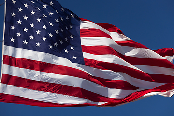 Image showing American Flag Waving In Wind Against a Deep Blue Sky