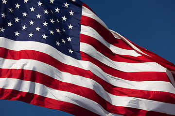 Image showing American Flag Waving In Wind Against a Deep Blue Sky