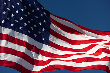 Image showing American Flag Waving In Wind Against a Deep Blue Sky