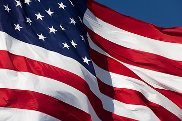 Image showing American Flag Waving In Wind Against a Deep Blue Sky