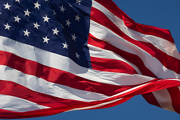 Image showing American Flag Waving In Wind Against a Deep Blue Sky