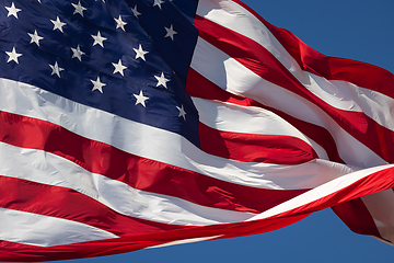 Image showing American Flag Waving In Wind Against a Deep Blue Sky