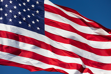 Image showing American Flag Waving In Wind Against a Deep Blue Sky