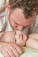 Image showing Mixed Race Chinese and Caucasian Baby Boy Laying In Bed with His