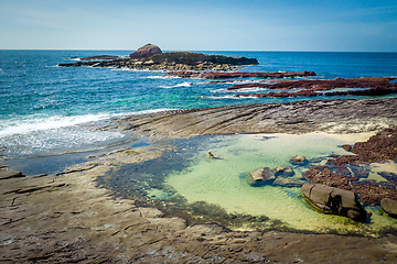 Image showing Female in bikini relaxing in ocean rockpools