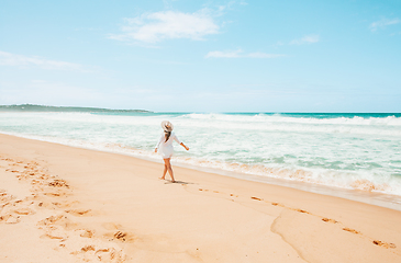 Image showing Woman walking along the beach on beautiful summer day in Austral
