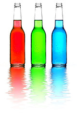 Image showing bottles red green and blue with reflection isolated