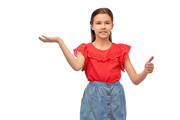 Image showing happy girl showing thumbs up and holding something