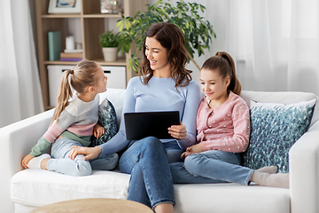 Image showing happy mother and daughters with tablet pc at home