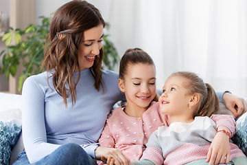 Image showing happy smiling mother with two daughters at home