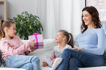 Image showing girl giving present to younger sister at home