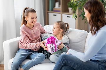 Image showing daughters giving present to happy mother