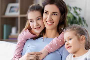 Image showing happy smiling mother with two daughters at home