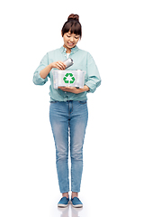 Image showing smiling young asian woman sorting metallic waste