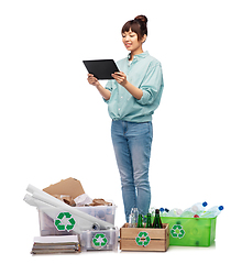 Image showing smiling asian woman with tablet pc sorting waste