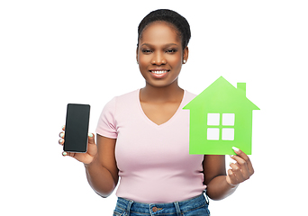 Image showing african woman with smartphone and green house