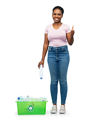 Image showing smiling young asian woman sorting plastic waste