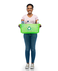 Image showing smiling young asian woman sorting plastic waste