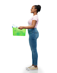 Image showing smiling young asian woman sorting plastic waste