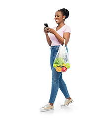 Image showing woman with smartphone and food in string bag